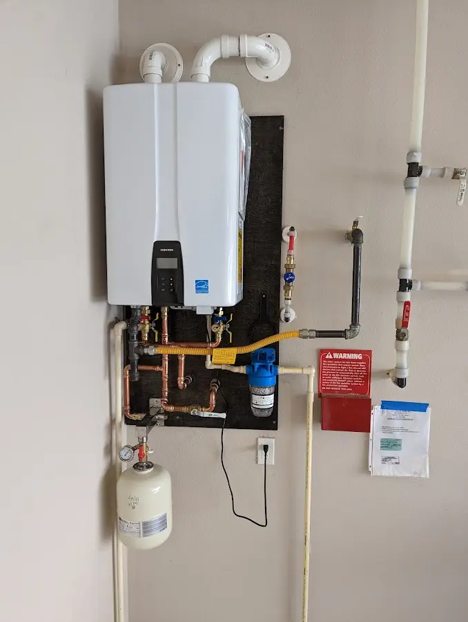 Professional plumber installing copper piping in a Short Pump home